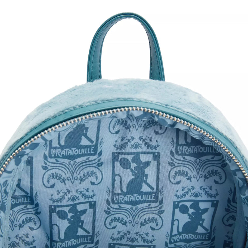 Close-up of the inside of a light blue plush backpack with a teal zipper and handle, featuring a repeating dark blue 'Le Ratatouille' character print.