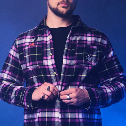 Man wearing a purple plaid shirt against a blue background