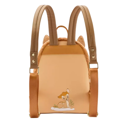 A mini backpack styled like a cat-shaped bag, featuring tan faux-leather straps, a peach-colored front panel with an embroidered Bambi character, and faux fur trim, shown on a plain white background.