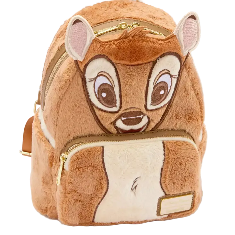 A plush mini backpack designed like the character Bambi, featuring brown faux fur, embroidered facial details, gold zippers, and a small blank name patch on the front pocket, shown on a white background.
