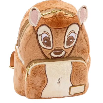A plush mini backpack designed like the character Bambi, featuring brown faux fur, embroidered facial details, gold zippers, and a small blank name patch on the front pocket, shown on a white background.