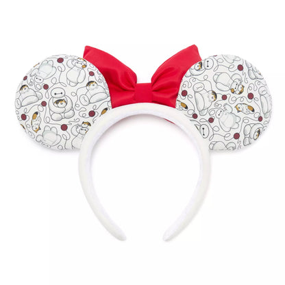 Disney Minnie Mouse-inspired mouse ears headband featuring a white patterned fabric with cartoon characters, a bright red bow, and a white padded headband.