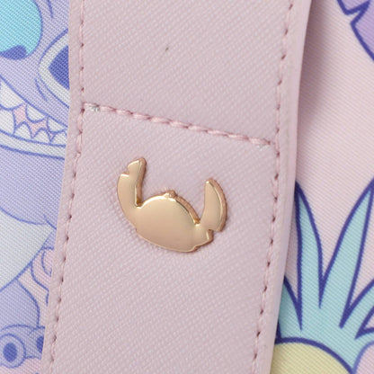 Close-up of a pink textured surface with a gold crab emblem and colorful background