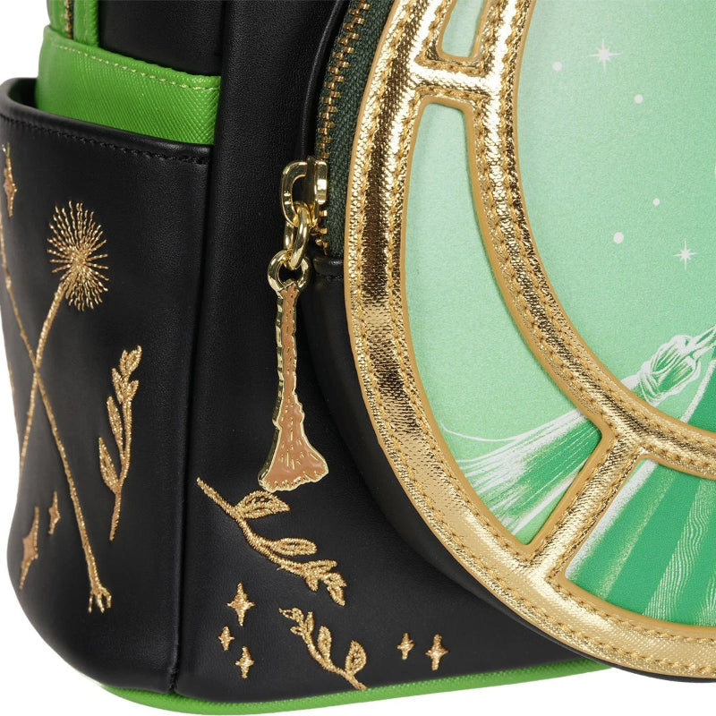 Close-up of a black and green handbag with gold accents and floral designs.