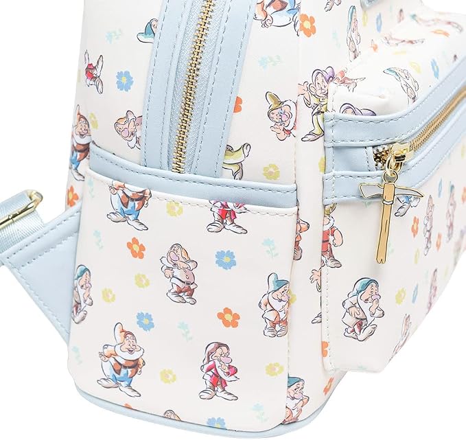 A close-up of a small backpack featuring an all-over print of Disney's Snow White characters and flowers on a white background, with light blue trim and gold-tone zippers.