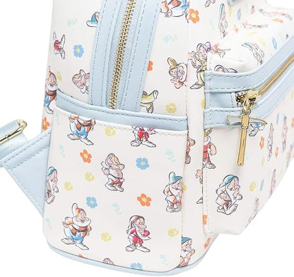 A close-up of a small backpack featuring an all-over print of Disney's Snow White characters and flowers on a white background, with light blue trim and gold-tone zippers.