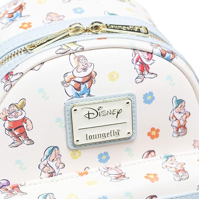 Close-up of a Disney Loungefly bag featuring an all-over print of the Seven Dwarves on a cream background with light blue trim and gold zipper hardware.