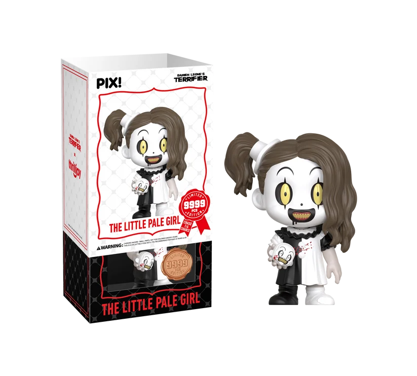 PIX! The Little Pale Girl vinyl figure in a black-and-white dress holding a small clown head, beside her box with the white sleeve slid partway off.