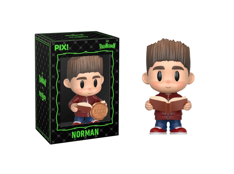 PIX! Norman vinyl figure in a red jacket holding an open book, shown beside its black window box with the figure visible inside.