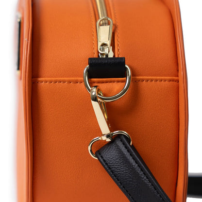Close-up of an orange backpack with a gold zipper and black strap.