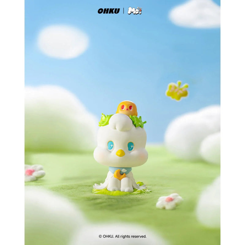 Toy figure of a cute character with a blue sky and white clouds in the background