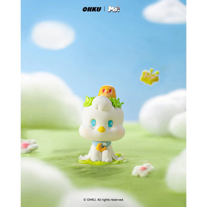 Toy figure of a cute character with a blue sky and white clouds in the background
