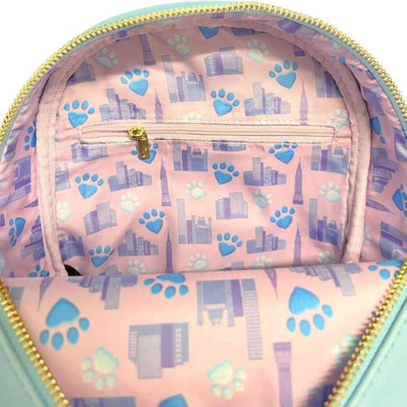 Pink backpack with blue paw prints and cityscape design, gold zipper
