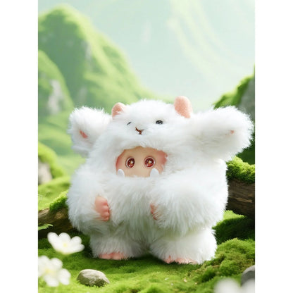 Plush toy resembling a white creature with pink accents on a green, natural background