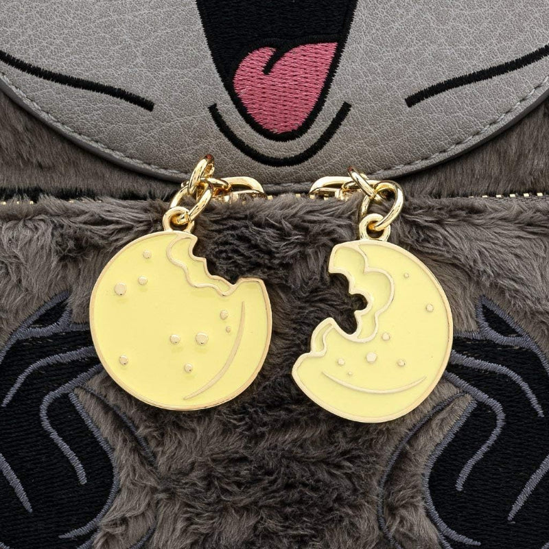 Gold earrings shaped like a moon and a cookie on a plush toy background