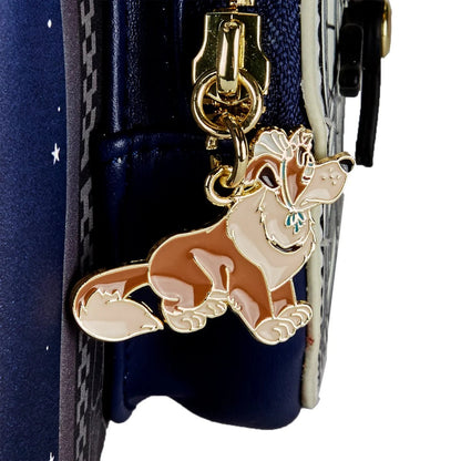 Dog-shaped keychain attached to a blue bag