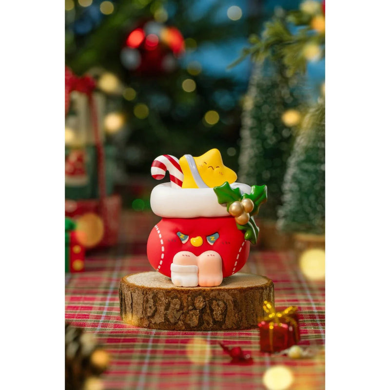 Decorative Christmas ornament on a wooden base with a blurred festive background