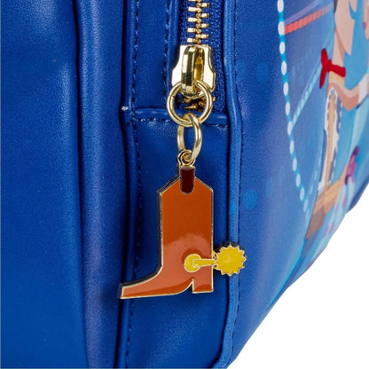 Close-up of a blue leather zippered bag with a gold zipper pull and a cowboy boot-shaped charm with a small yellow star accent.