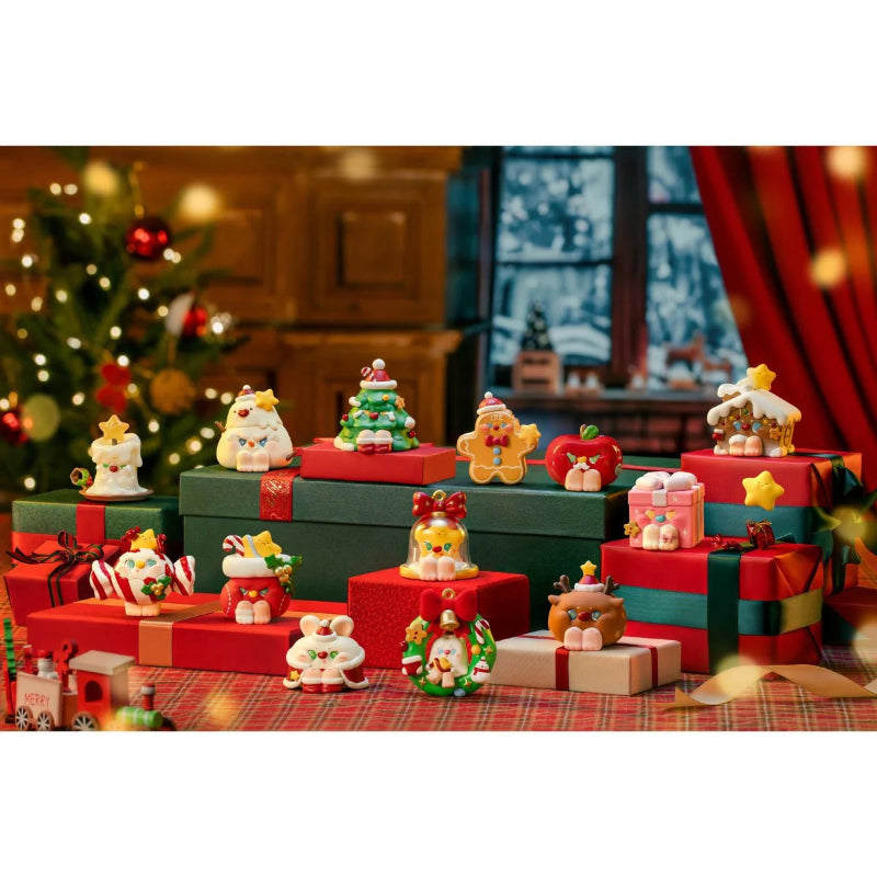 Christmas-themed decorative set with presents and figurines on a table.