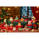 Christmas-themed decorative set with presents and figurines on a table.