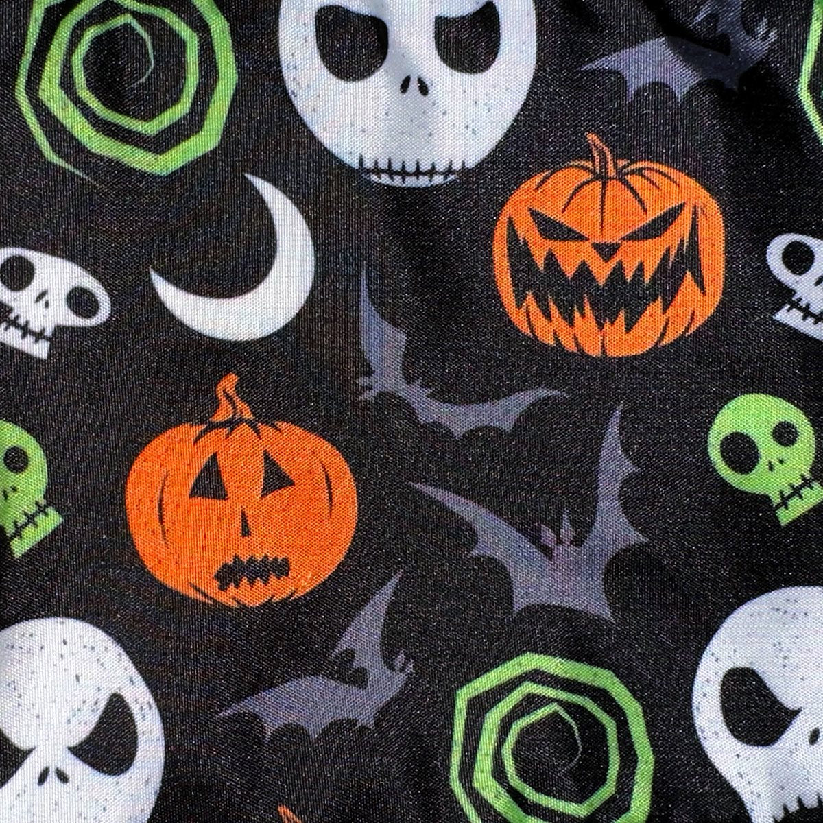 Halloween-themed fabric with pumpkins, skulls, and bats on a black background