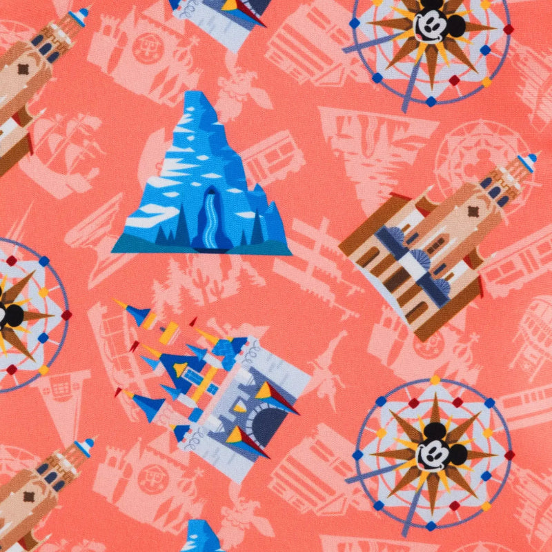 Patterned fabric with cartoon castle, mountain, and compass design on a pink background