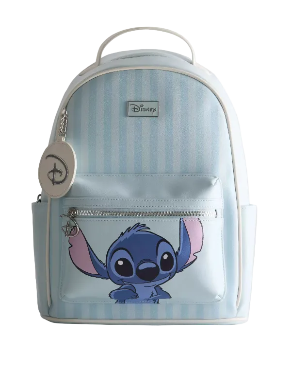 A Disney backpack featuring a light blue and white vertical stripe pattern, with a large graphic of Stitch on the front pocket. The backpack has a top handle, a front zippered pocket, a silver zipper, and a round Disney keychain charm hanging from the left side.