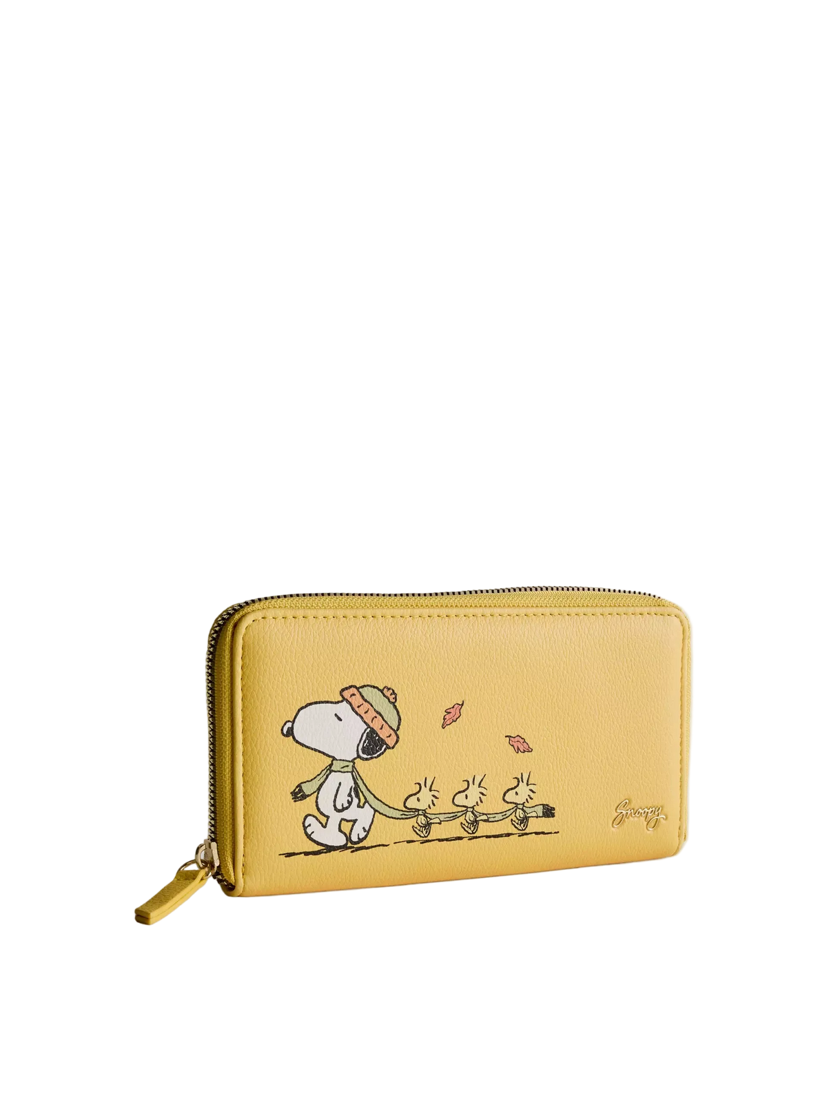 A yellow zip-around wallet featuring a printed cartoon illustration of Snoopy and the Beagle dogs walking under falling leaves, shown on a light gray background.