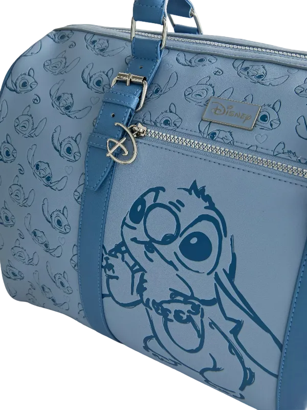 A light blue Disney Lilo & Stitch duffle bag featuring a large blue line-art print of Stitch on the front, an allover Stitch pattern on the sides, a top handle, a zippered compartment, and a visible Disney logo plaque.