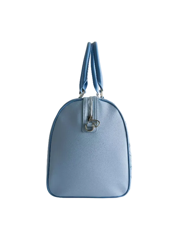 A light blue leather handbag with a rounded dome shape, dual top handles, and a silver-tone zipper closure with a decorative metal ring, shown against a plain light gray background.