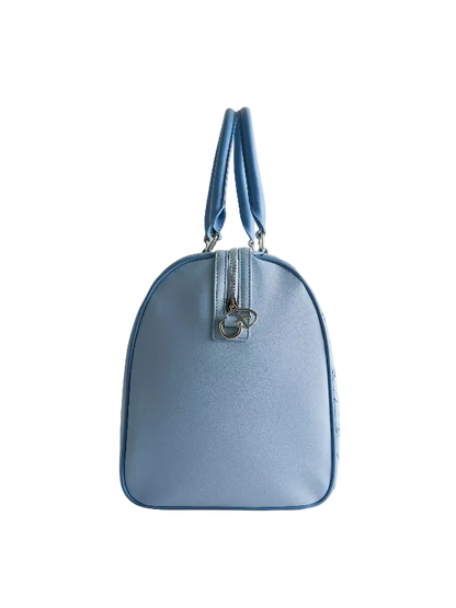 A light blue leather handbag with a rounded dome shape, dual top handles, and a silver-tone zipper closure with a decorative metal ring, shown against a plain light gray background.