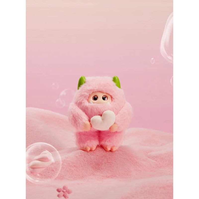 Cute plush toy with a heart on a pink background