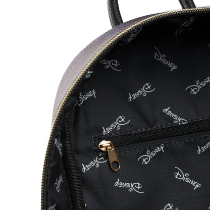 Close-up of a Disney backpack interior showing a black fabric lining with a repeating white Disney logo pattern, a black zipper pocket with a gold-tone pull, and part of the dark gray exterior with gold zipper trim.