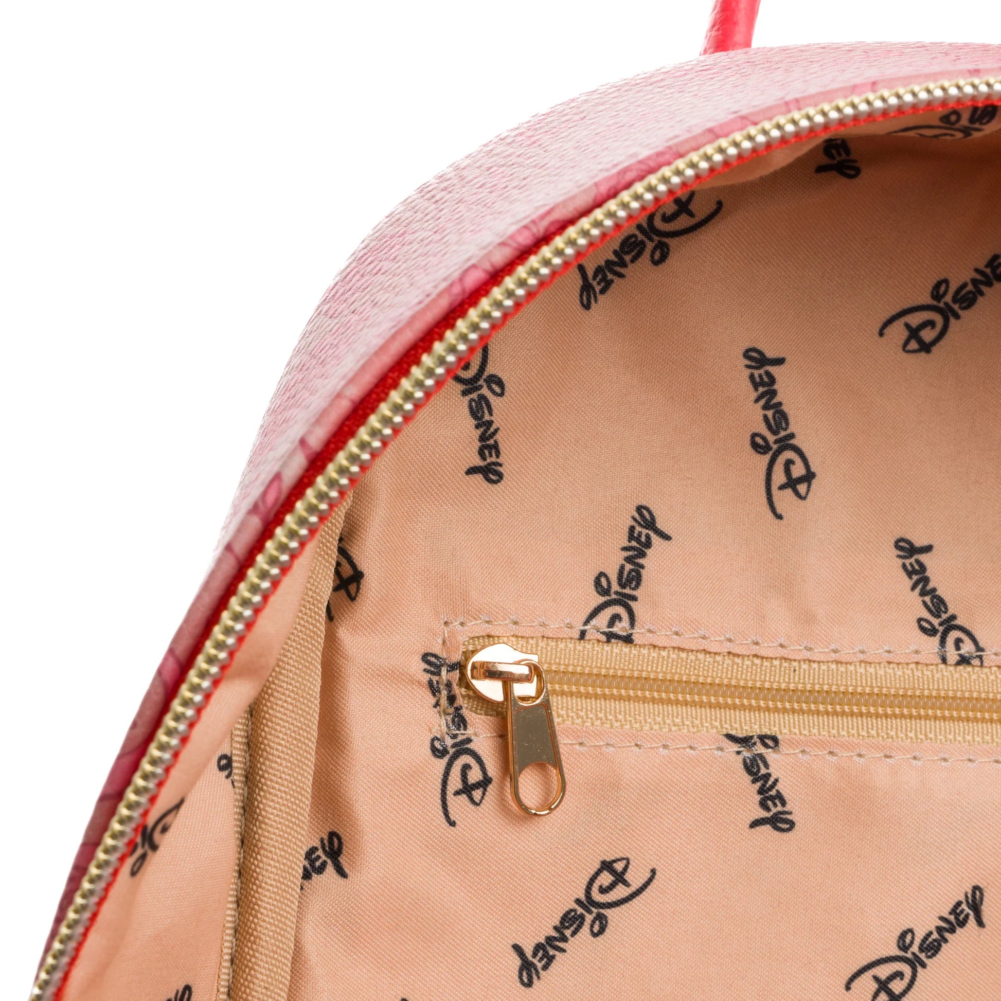 Close-up of a pink backpack with gold zipper and Disney logo pattern on beige interior.