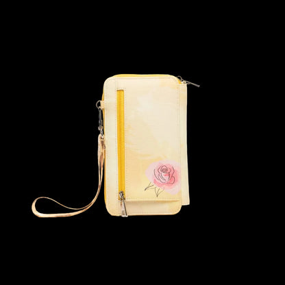 A pale yellow waterproof pouch wallet with a pink rose illustration on the front, featuring a vertical yellow zipper, a wristlet strap, and a top zip closure, shown on a plain white background.