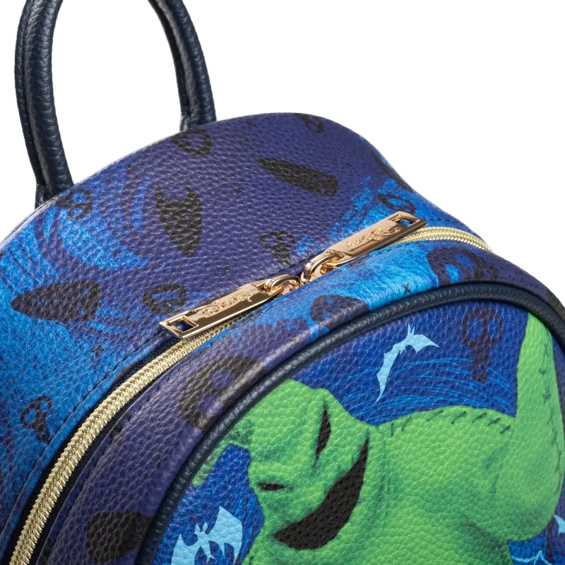 Blue and green patterned bag with a gold zipper on a white background