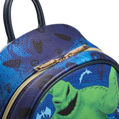 Blue and green patterned bag with a gold zipper on a white background