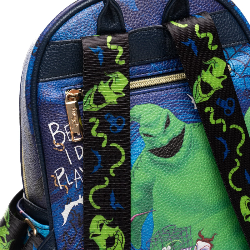 Backpack with green alien design and colorful straps on a blue background