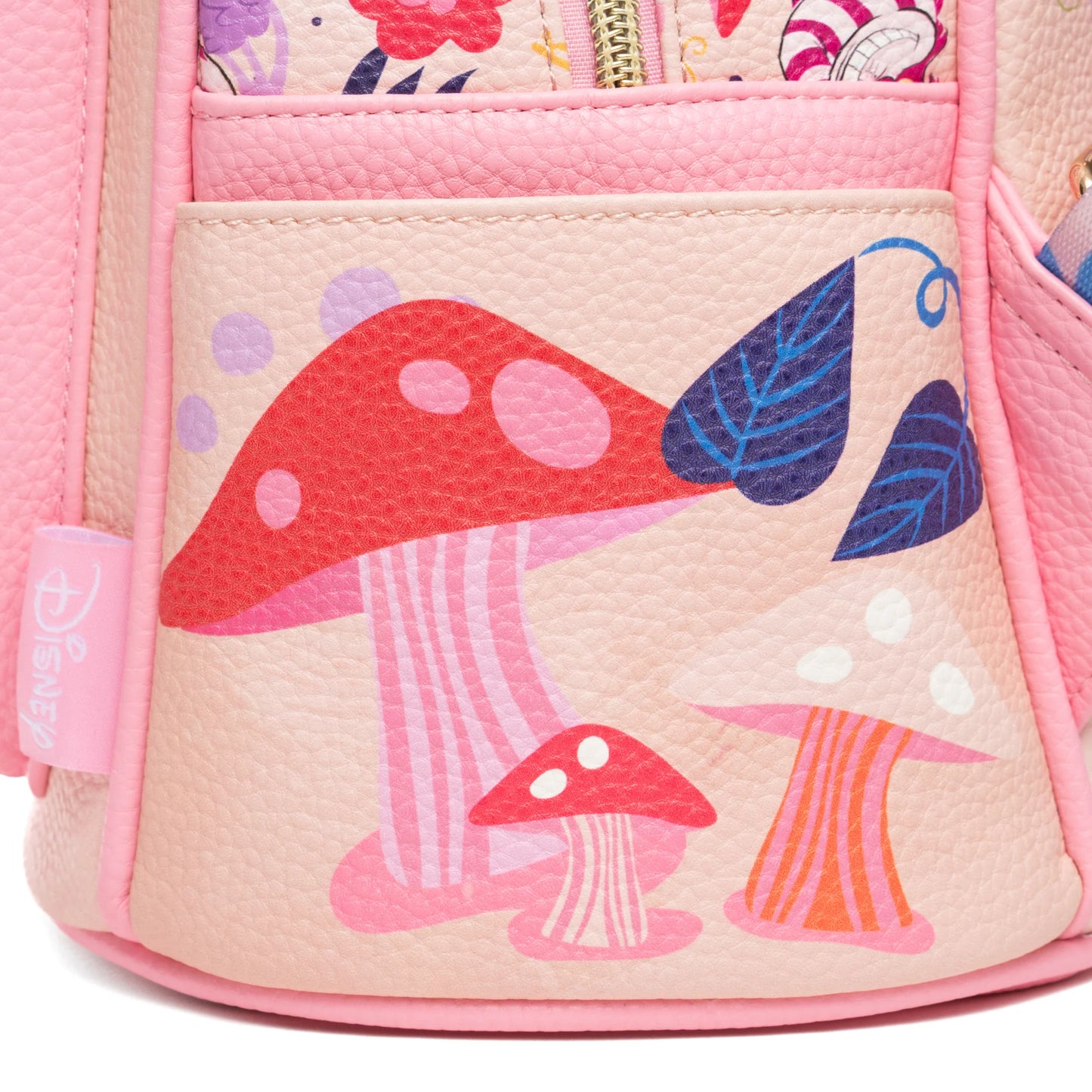 Close-up of a pink children's backpack with mushroom and butterfly design.