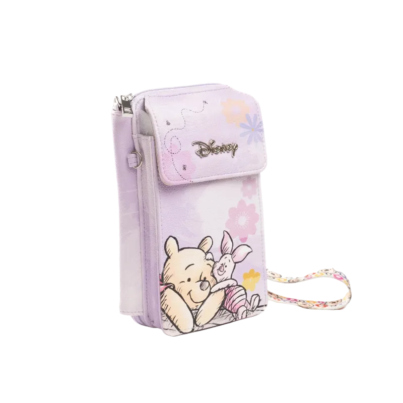 A light purple Disney crossbody phone pouch featuring Winnie the Pooh and Piglet illustrations, with a matching floral wrist strap, shown on a white background.