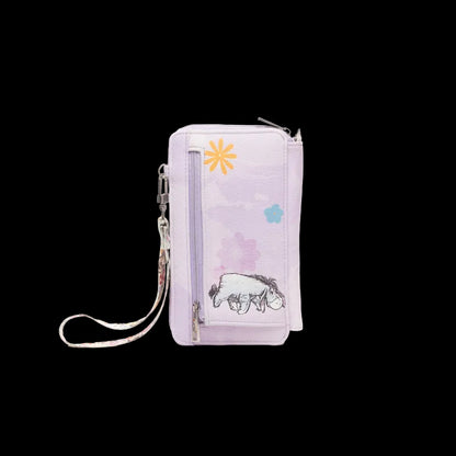 A light purple crossbody phone bag featuring a printed illustration of Eeyore the donkey, a yellow flower, and a blue flower on a white background.