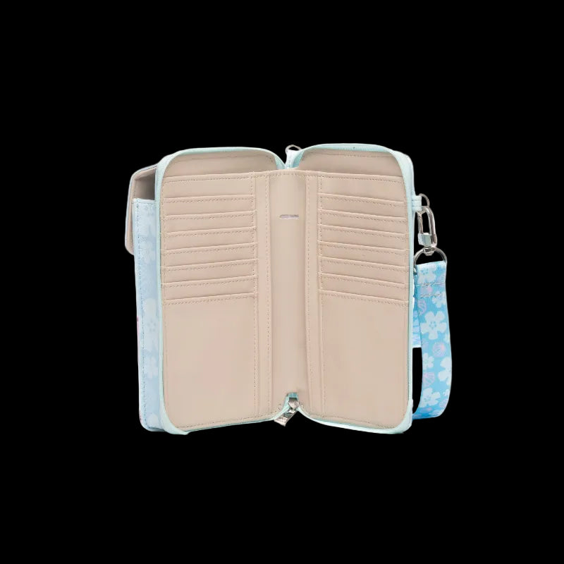 An open two-compartment wallet with a light blue patterned exterior, beige interior lining, and a matching blue patterned wristlet strap on a white background.