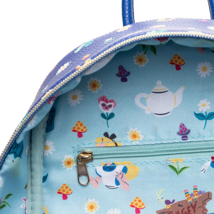 Backpack with a colorful pattern of teapots, flowers, and mushrooms on a light blue background.