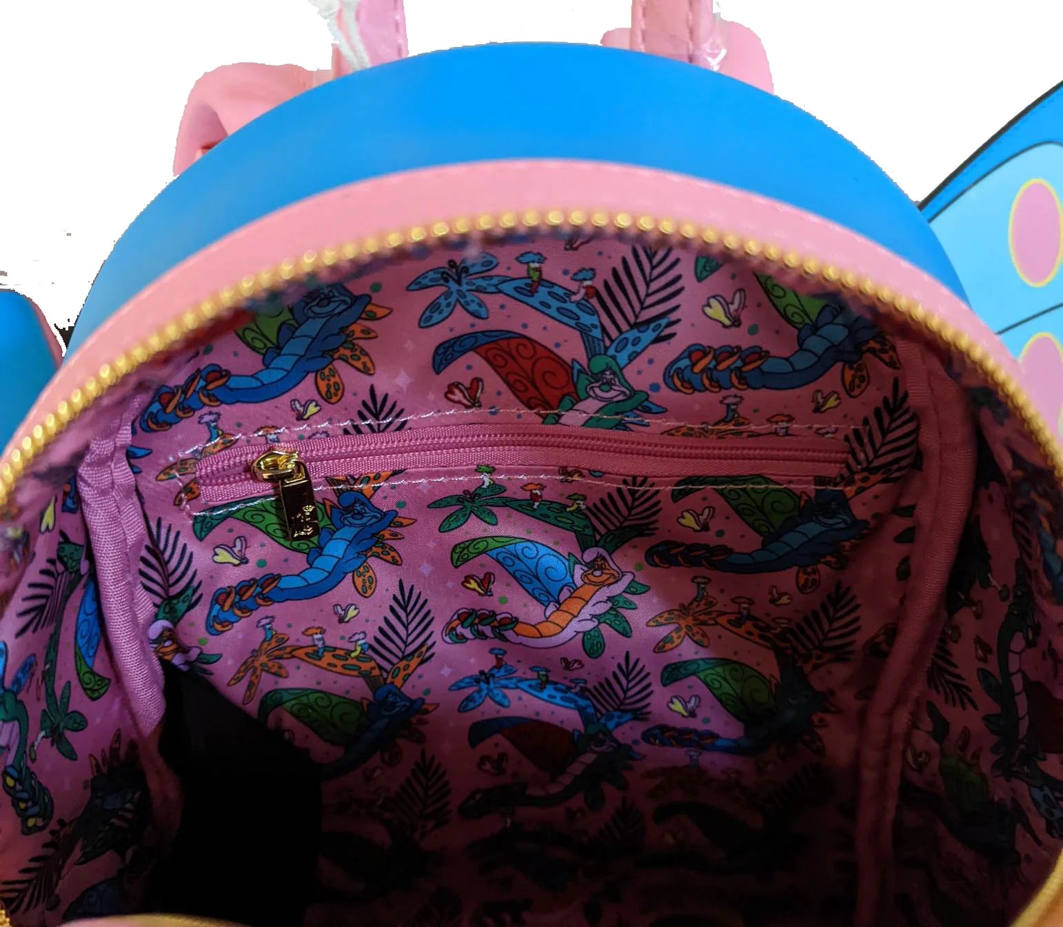 Pink backpack with colorful mermaid pattern on a white background
