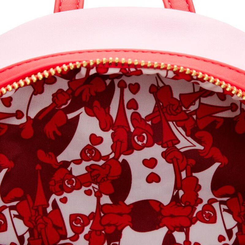 Close-up of a red and white patterned bag with a gold zipper.