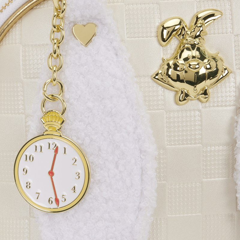 Gold pocket watch charm with a rabbit design on a textured white background