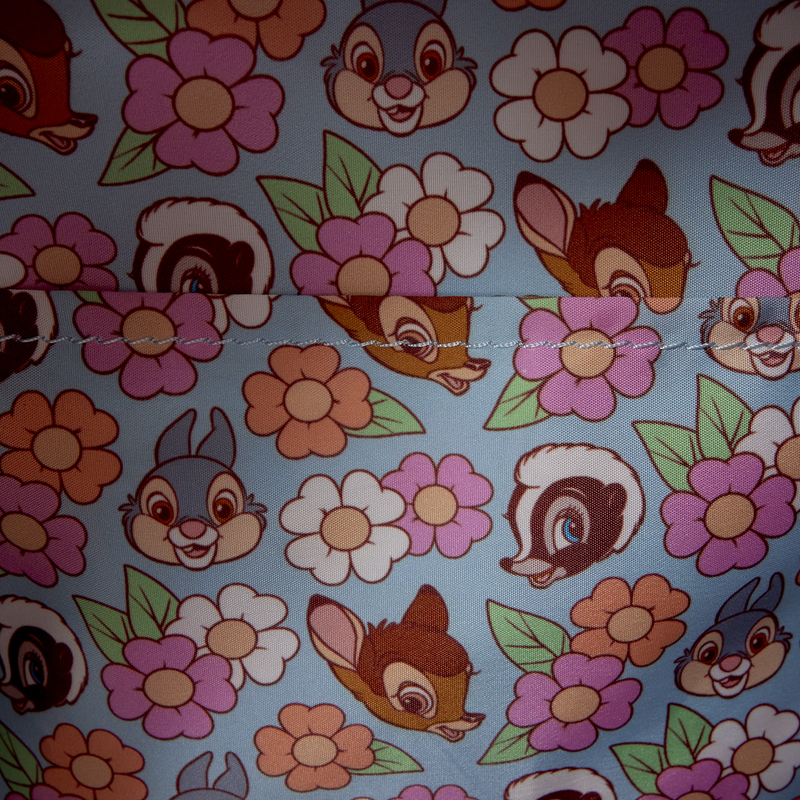 Pattern of cartoon characters and flowers on a blue background