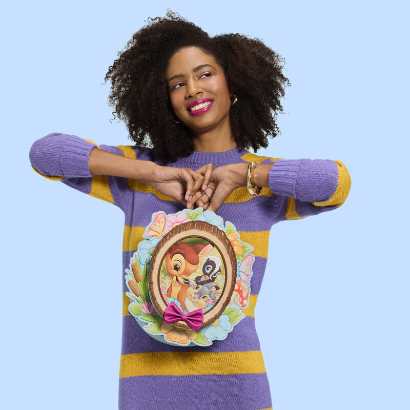 Woman wearing a colorful sweater with cartoon design on a blue background