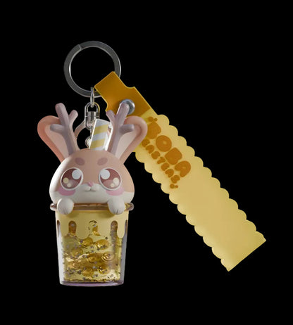 Keychain with a cartoon bunny design and gold glittery container on a white background