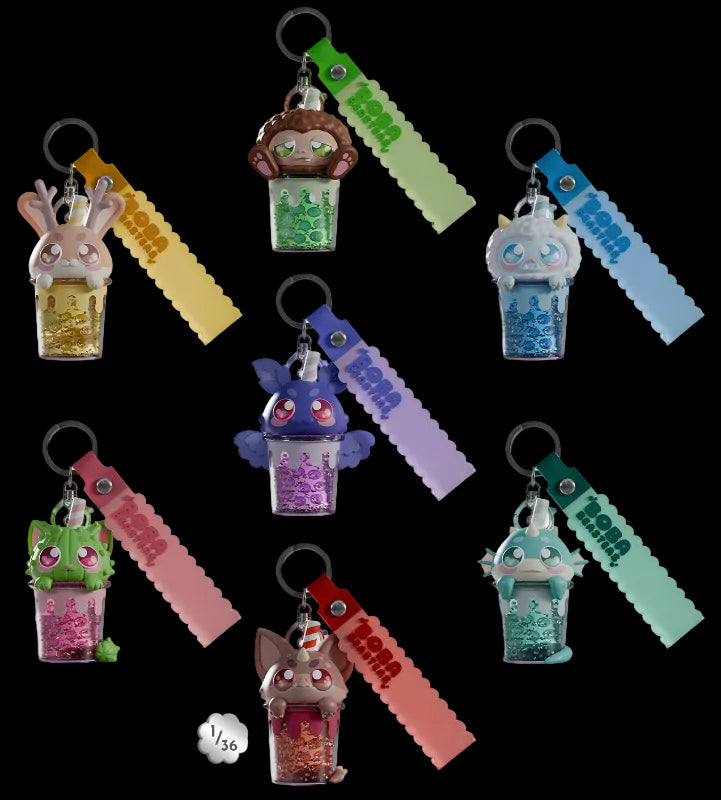 Collection of colorful keychains with character designs on a light gray background